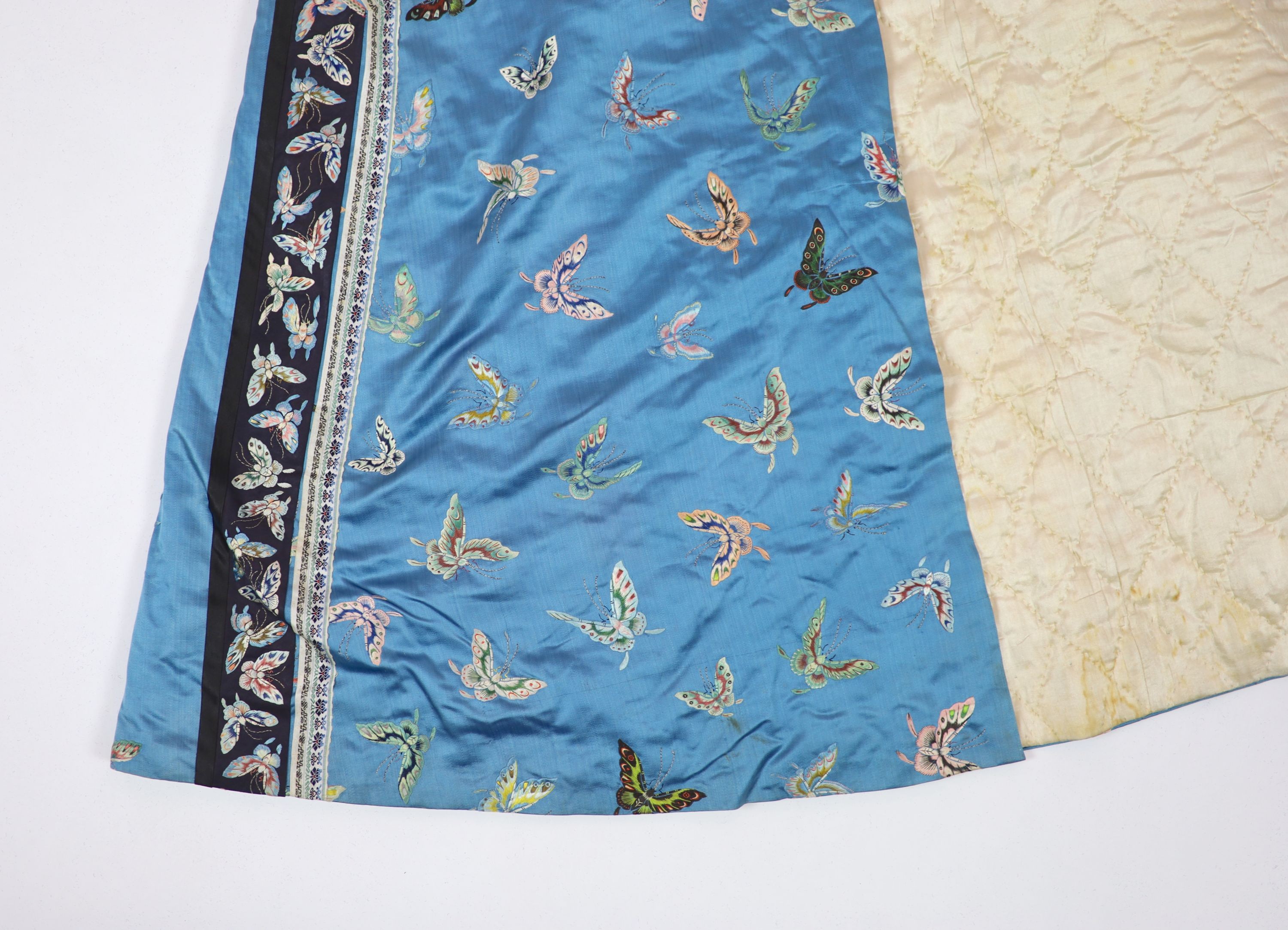 A Chinese blue silk ‘butterfly’ Winter robe, late 19th century, 132cm drop